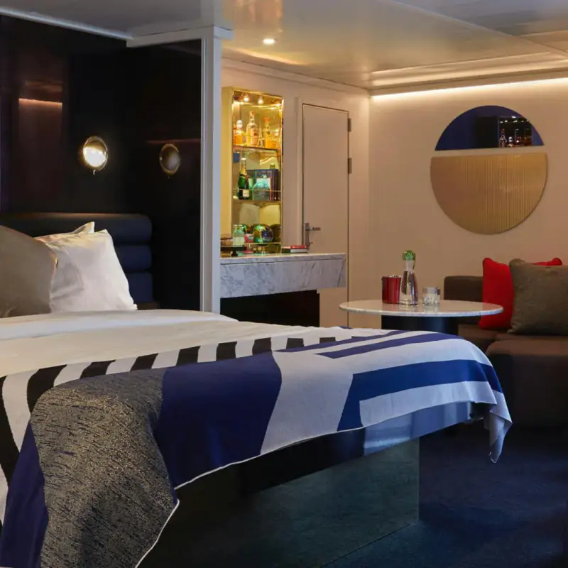 Virgin Voyages Cheeky Corner Suite bedroom and terrace doorway