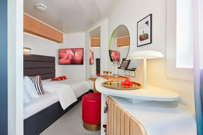 Virgin Voyages Solo Sea View cabin with a bed and vanity