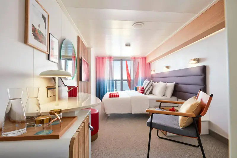 Virgin Voyages XL Sea Terrace cabin with a bed and sitting area