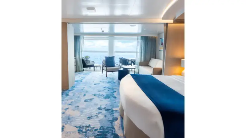 icon of the seas infinite grand suite balcony bed living room vanity crop4