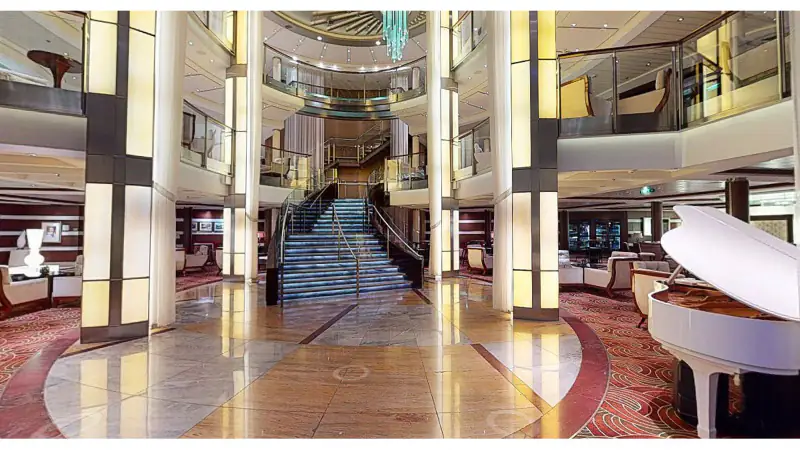 Celebrity Eclipse Grand Foyer with sweeping staircase and central tree