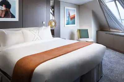 Renewed Horizon Suite bedroom with king bed and angled forward windows