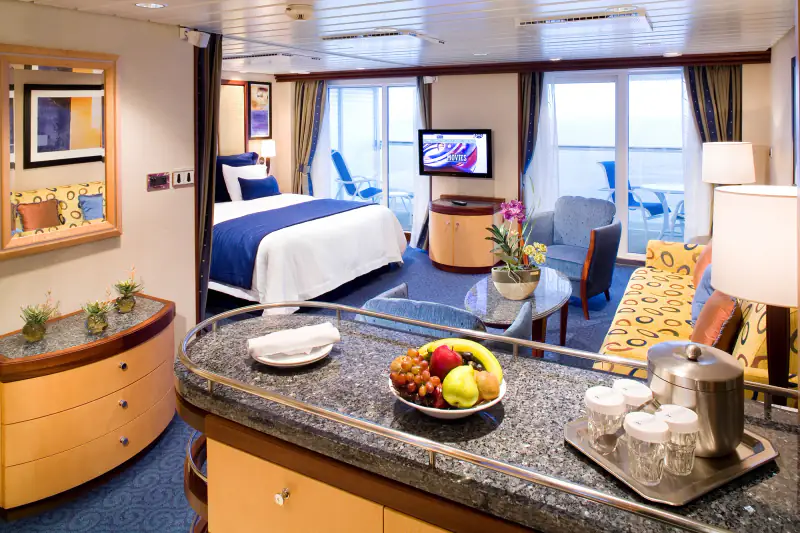 Royal Caribbean grand suite with a sitting area and bed