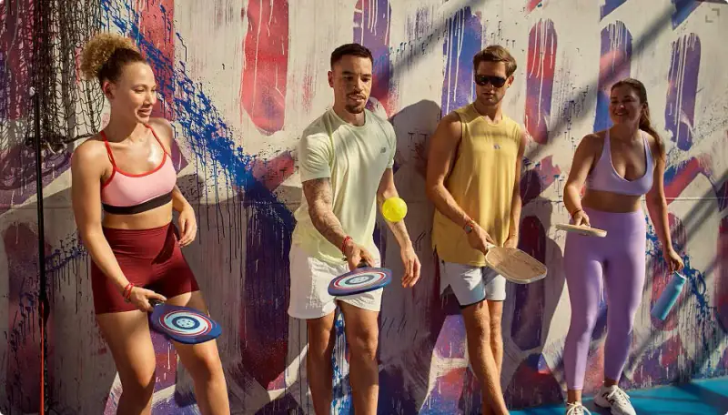 Four Sailors holding racquets and paddles at Brilliant Lady's Athletic Club