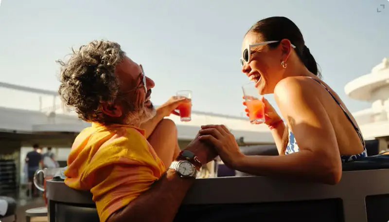 Sailors enjoying drinks together on an open deck aboard Resilient Lady