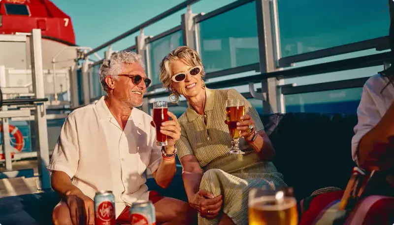 Sailors enjoying drinks on an open deck aboard Scarlet Lady