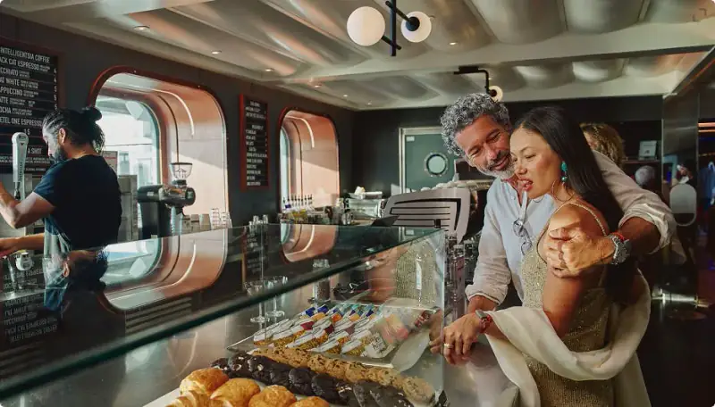 Pastries displayed at a food counter in The Galley aboard Scarlet Lady