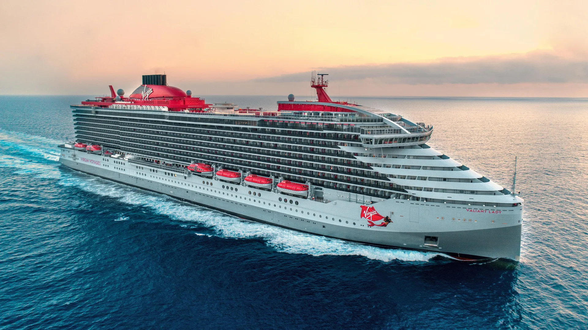 Aerial view of Valiant Lady sailing through calm water at sunset