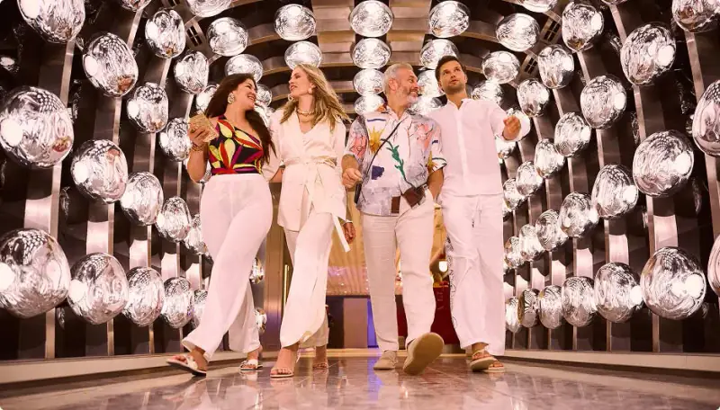Sailors walking through the mirrored light tunnel at The Manor aboard Valiant Lady