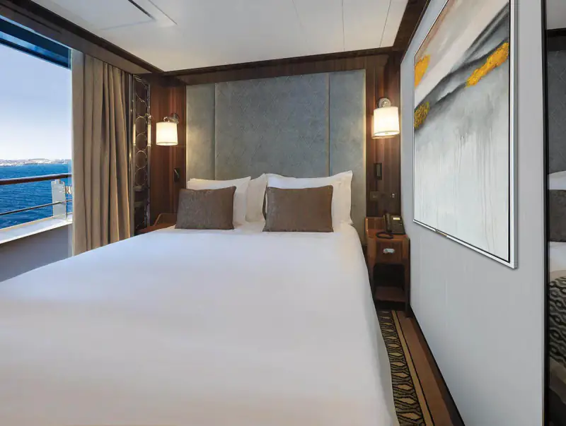 World Navigator Deluxe Veranda Suite bedroom and sitting space