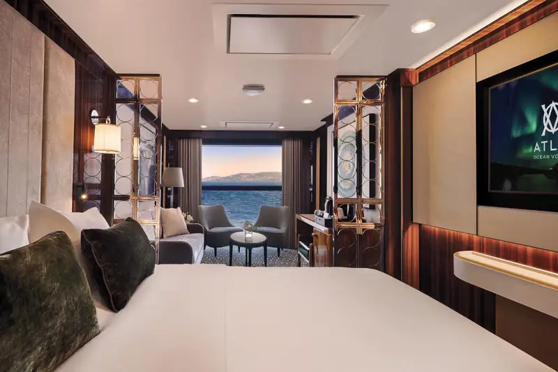 World Navigator Horizon Suite bedroom, seating, and tall window