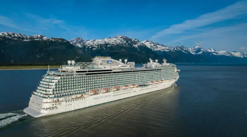 Discovery Princess sails past snow-capped mountains near Haines, Alaska.