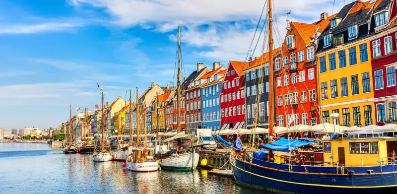 Colorful waterfront buildings line a canal in Copenhagen's Nyhavn harbor.