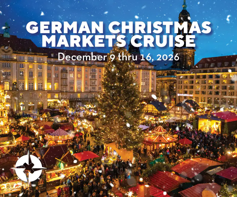 A busy German Christmas market glows beneath an illuminated historic city skyline in OUTbound's cruise artwork.