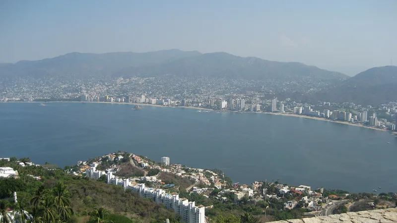 Acapulco Bay curving around beaches, hotels, and green hills
