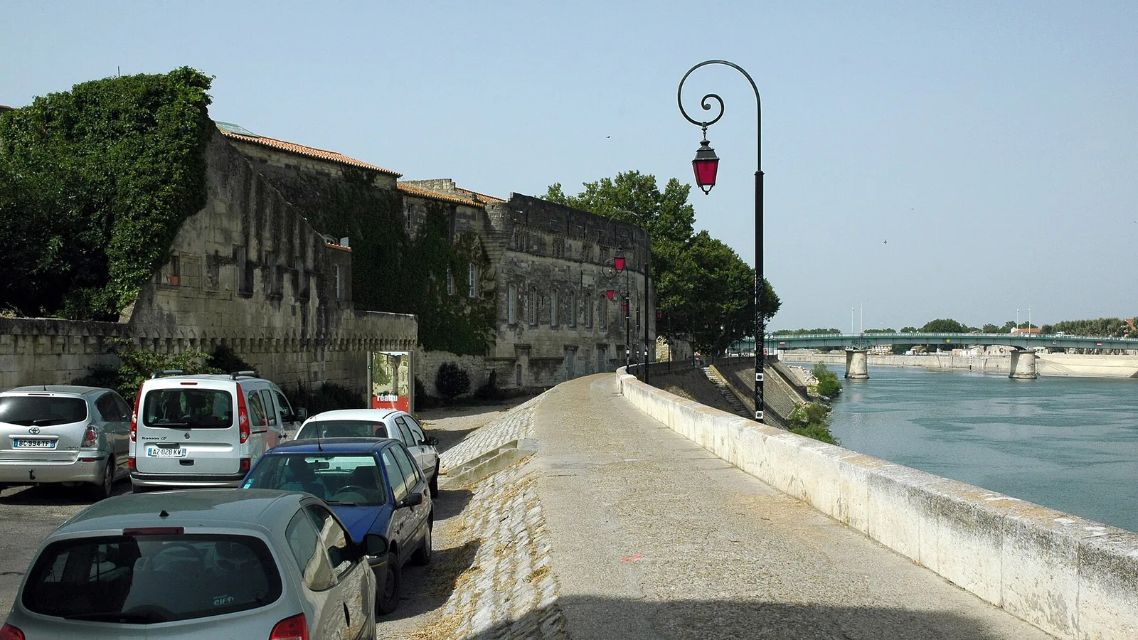 Stone buildings and riverside walkway along Quai Marx Dormoy in Arles, beside the Rhône