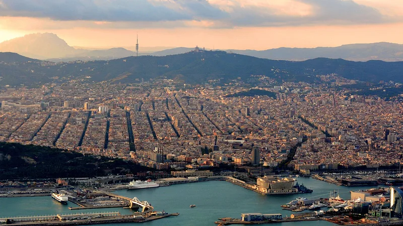 Barcelona city, harbor, and hills in warm evening light