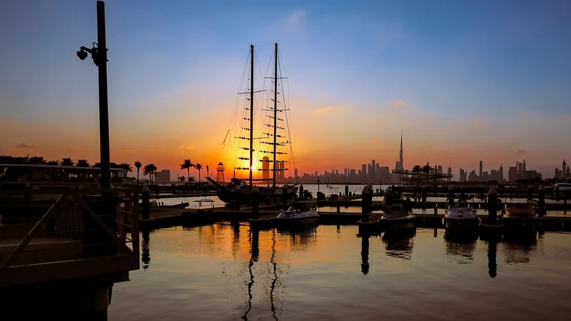 Dubai Creek harbor, modern skyline, boats, and blue water