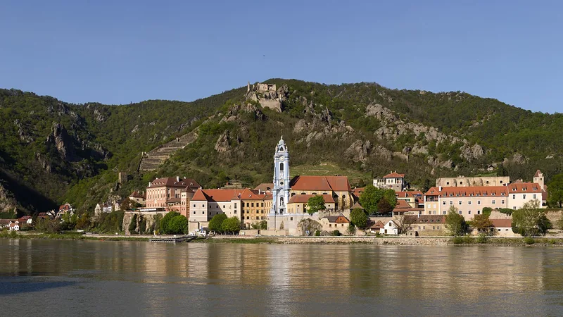Dürnstein's red roofs, blue abbey tower, castle ruins, and the Danube