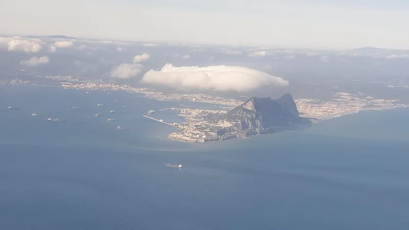 Aerial view of the Rock of Gibraltar, city, harbor, and Levanter cloud