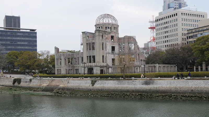 Hiroshima Peace Memorial across the river beneath a blue sky