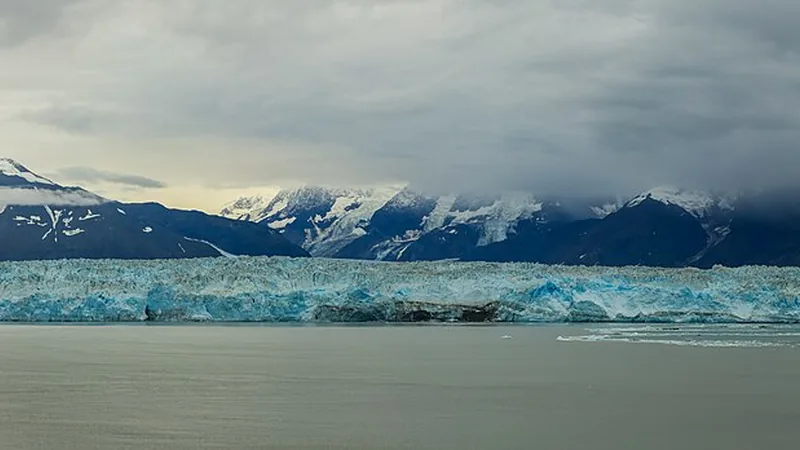 Hubbard Glacier face, floating ice, and cloud-covered mountains