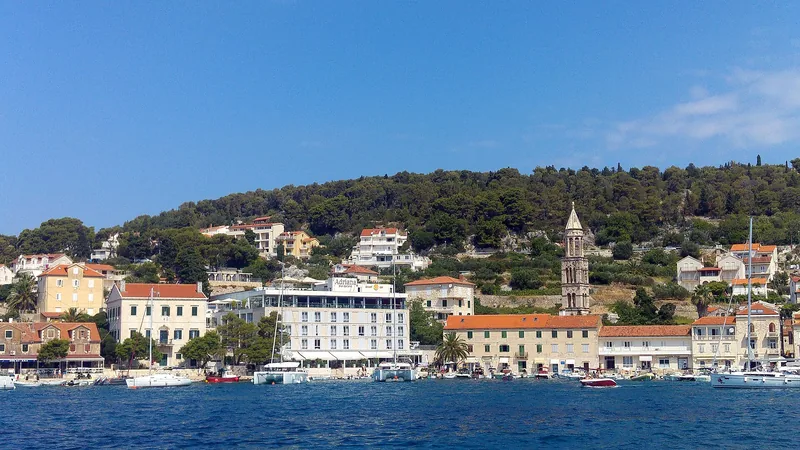 Hvar's stone waterfront and hillside town seen across the harbour