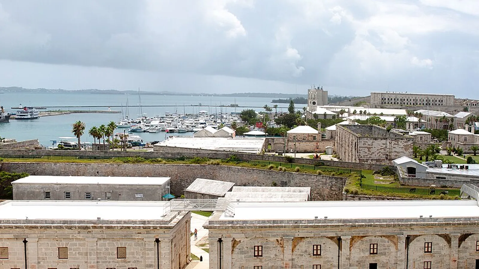Royal Naval Dockyard fortifications, marina, and a cruise ship beside Bermuda's blue water