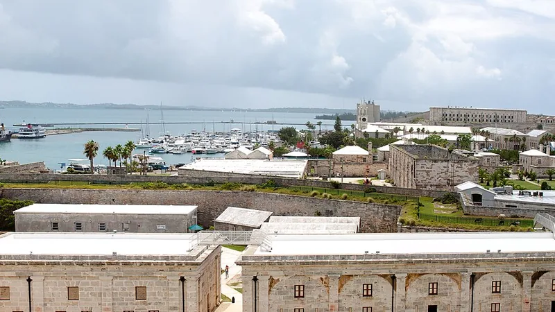 Royal Naval Dockyard fortifications, marina, and a cruise ship beside Bermuda's blue water