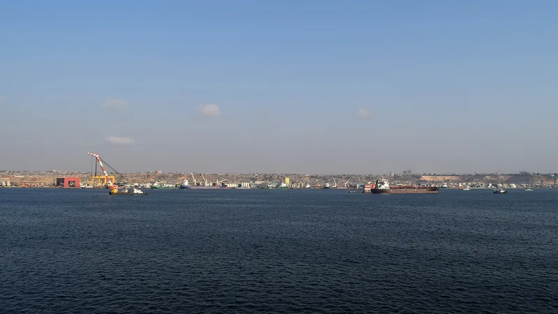 Cargo ships and harbor cranes across Luanda Bay in a historical 2015 view, not a current cruise berth map