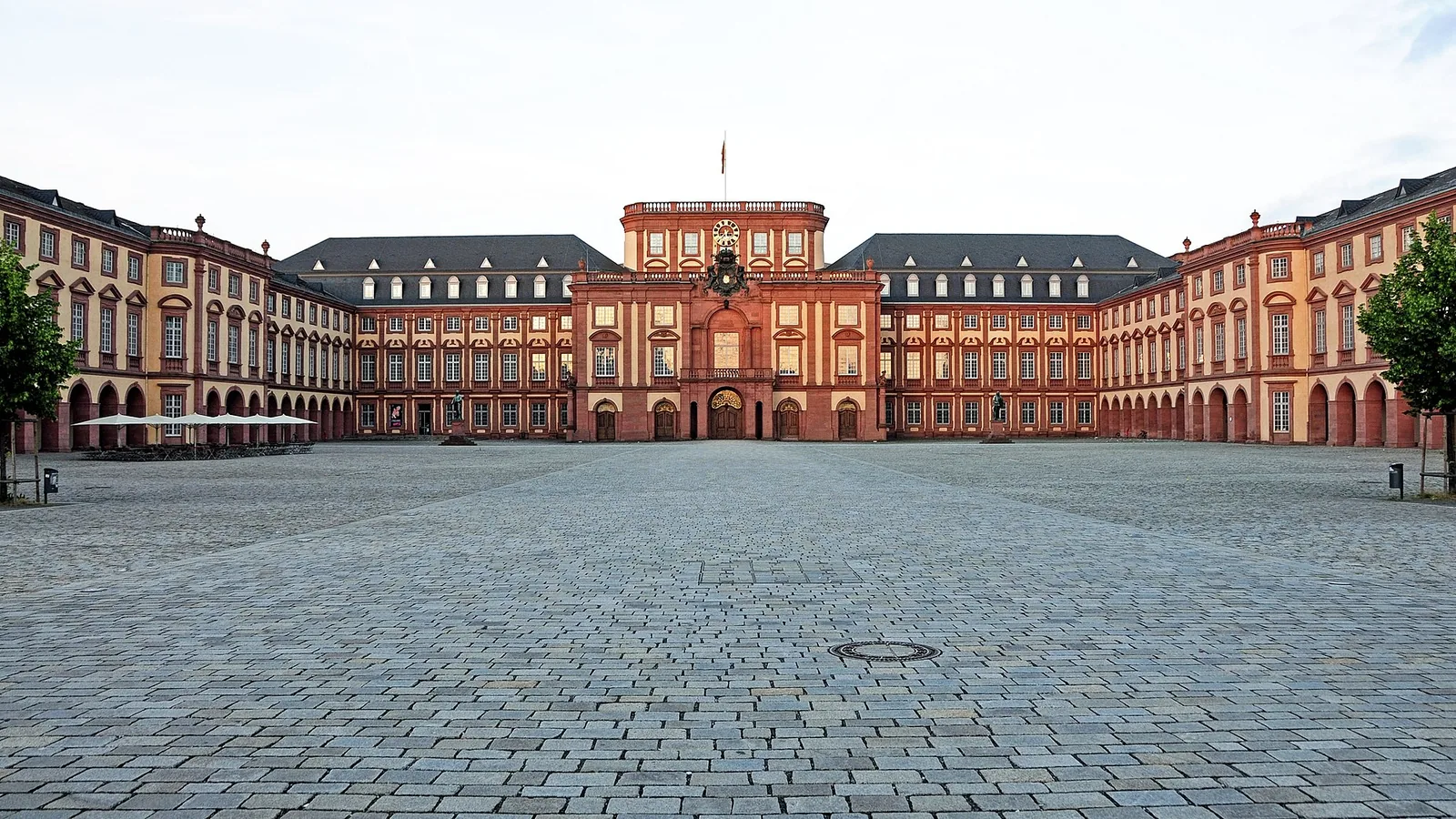 Red and cream façade of Mannheim Palace across the courtyard