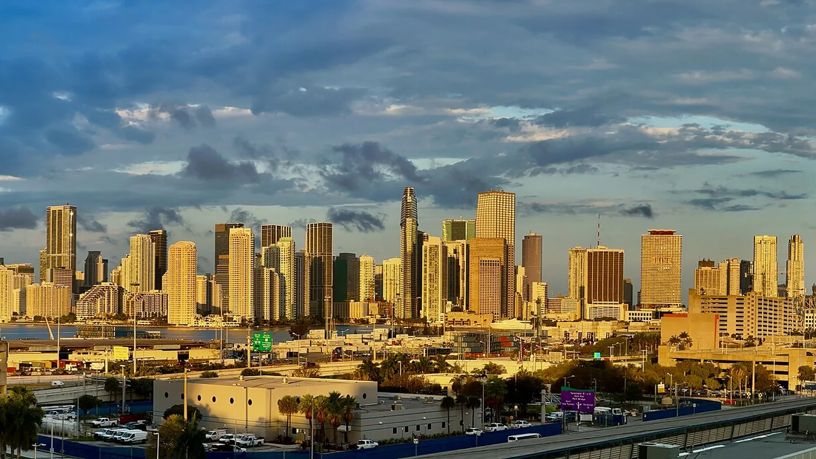 Miami skyline glowing at sunrise across Biscayne Bay