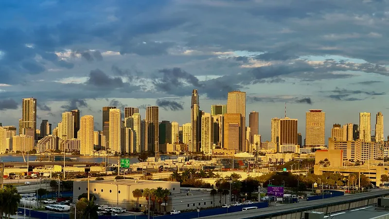 Miami skyline glowing at sunrise across Biscayne Bay