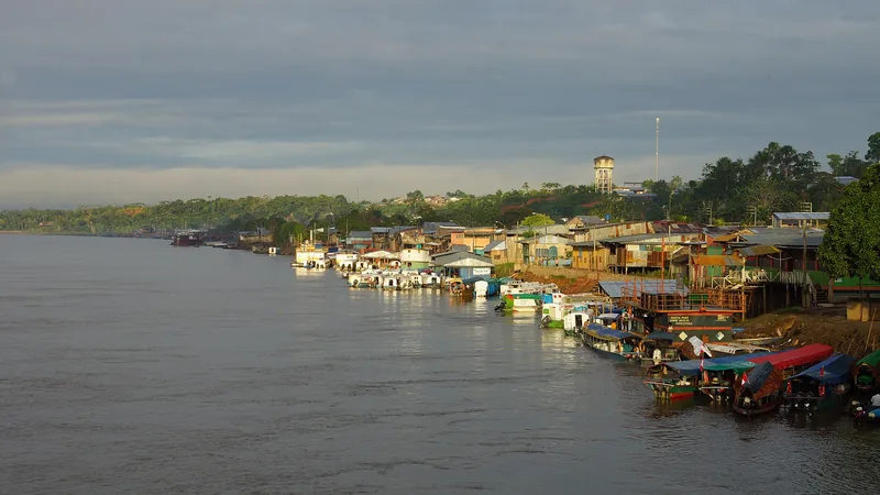 Riverfront buildings and moored boats along the Marañón at Nauta, shown in a historic photograph