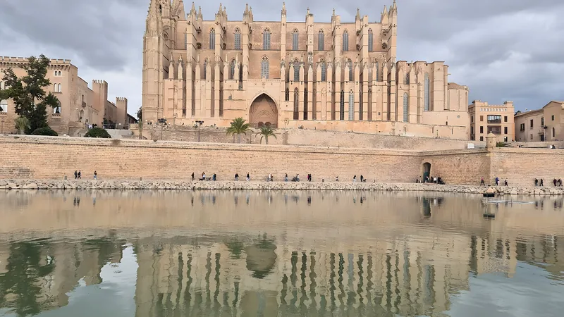 Palma Cathedral reflected in the water at Parc de la Mar