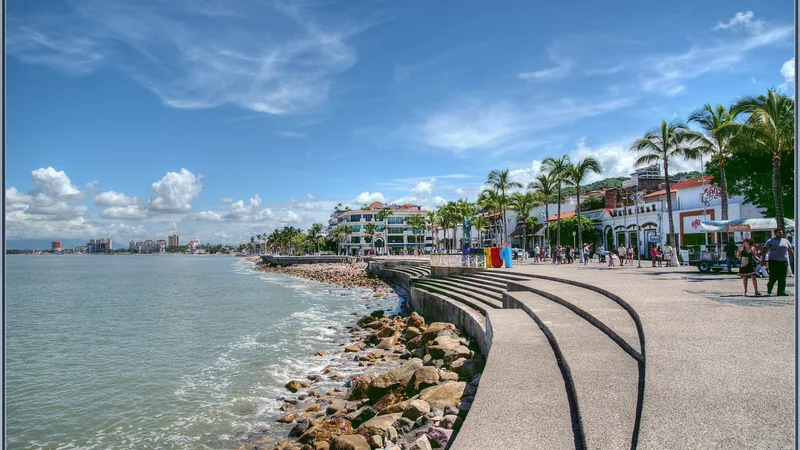 Puerto Vallarta Malecón, palm trees, sculptures, and Banderas Bay