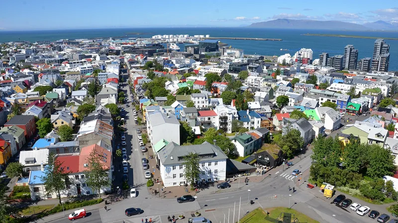 Colorful Reykjavik rooftops with water and mountains beyond