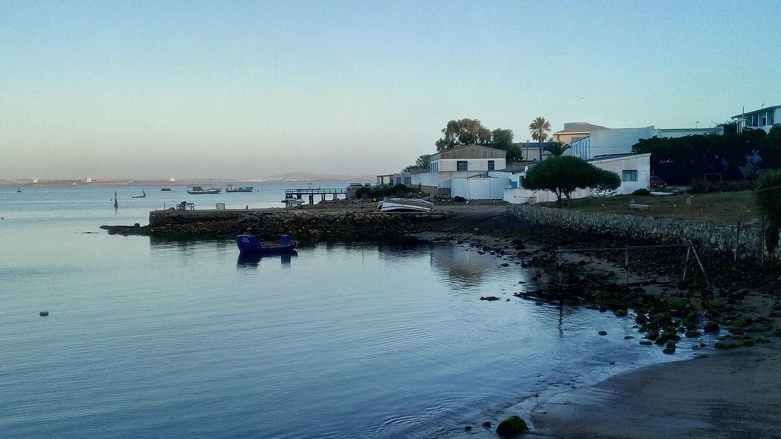 Boats and waterside buildings on Saldanha Bay in a historical 2018 shoreline view