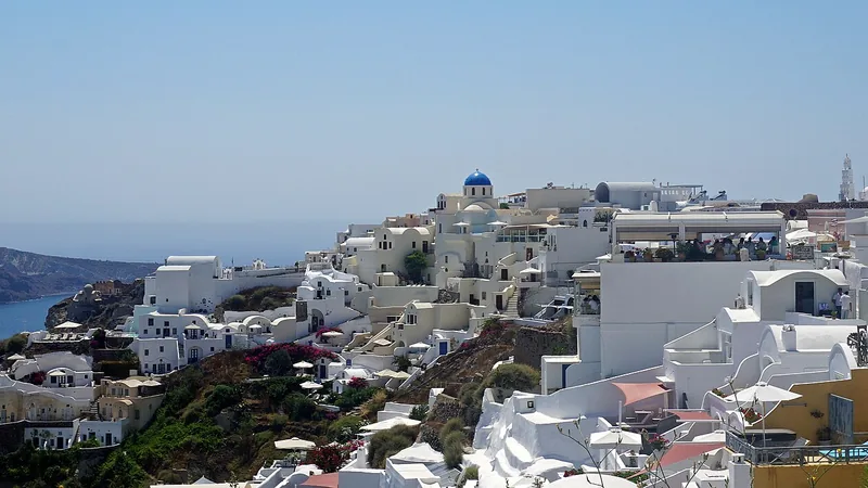 Whitewashed Oia village stretching along the Santorini caldera