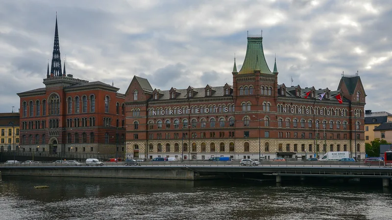 Norstedt Building, Riddarholmen church spire, bridge and waterfront in Stockholm; a historic city view