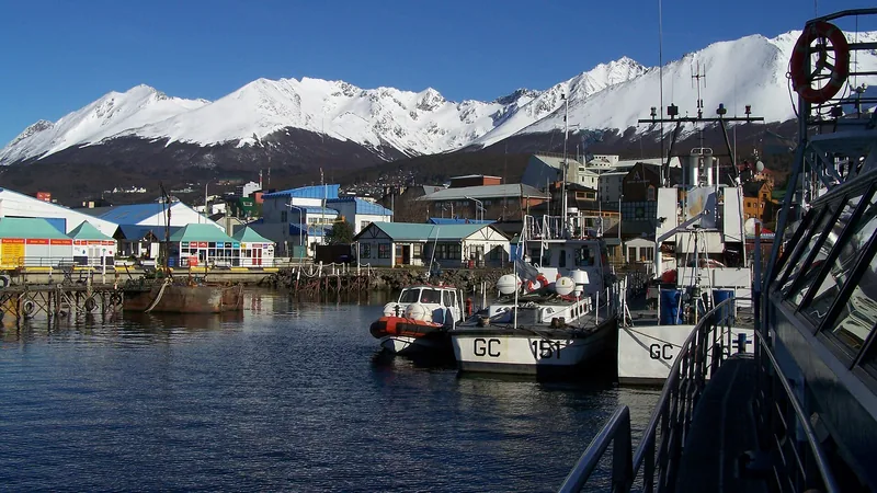 Ushuaia harbor, boats, city, and snow-dusted mountains