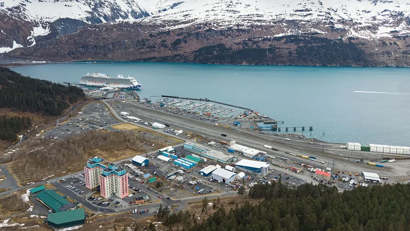 Aerial view of Whittier harbor, glacier-fed water, and steep mountains