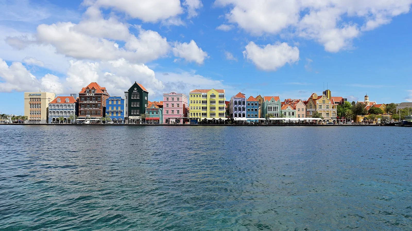 Colorful Handelskade waterfront buildings across Willemstad harbor