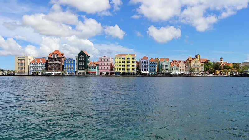 Colorful Handelskade waterfront buildings across Willemstad harbor